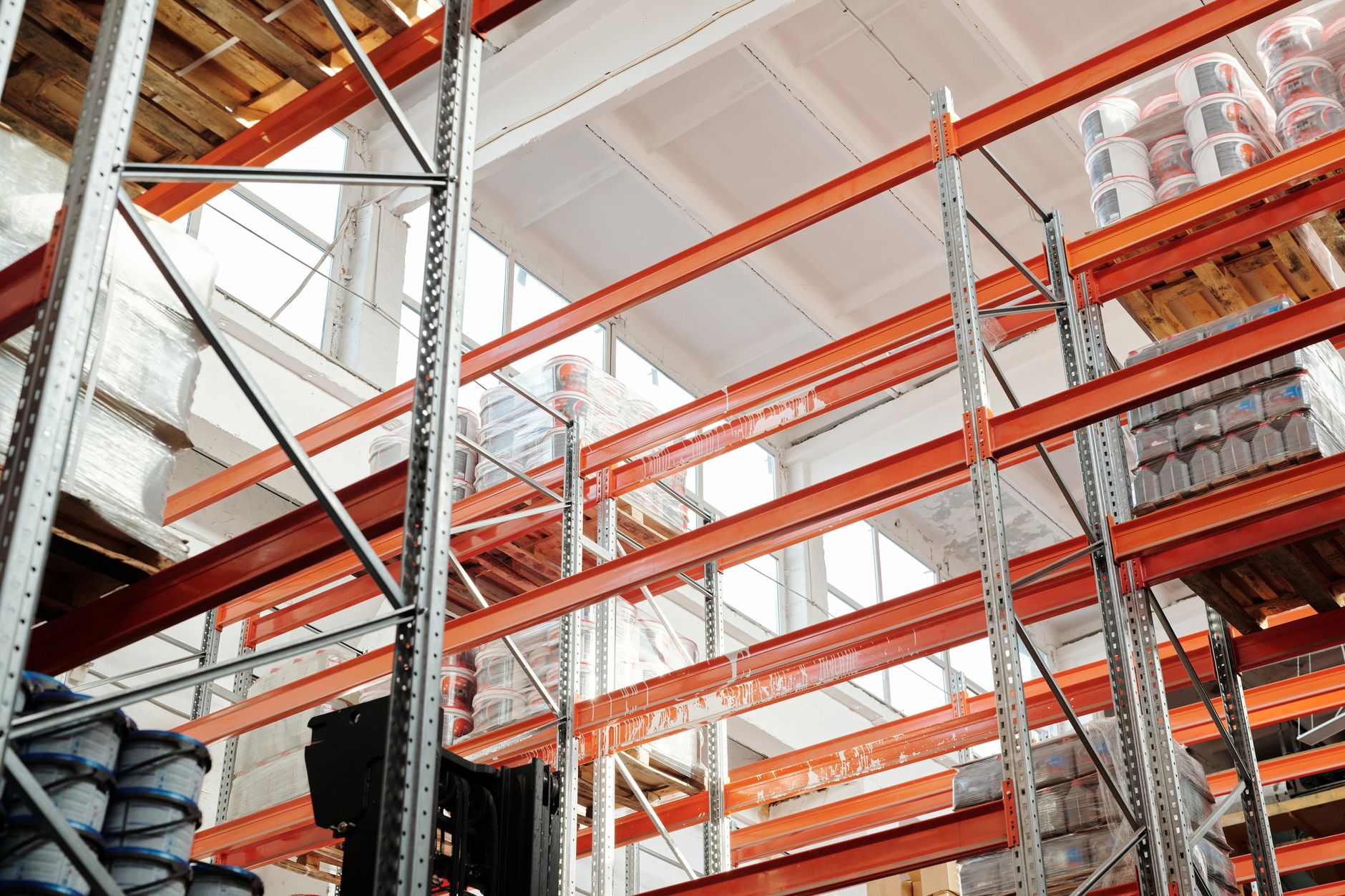 Bright warehouse interior with orange metal shelving units a