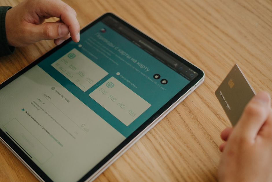 Hands making an online purchase using a tablet and credit ca