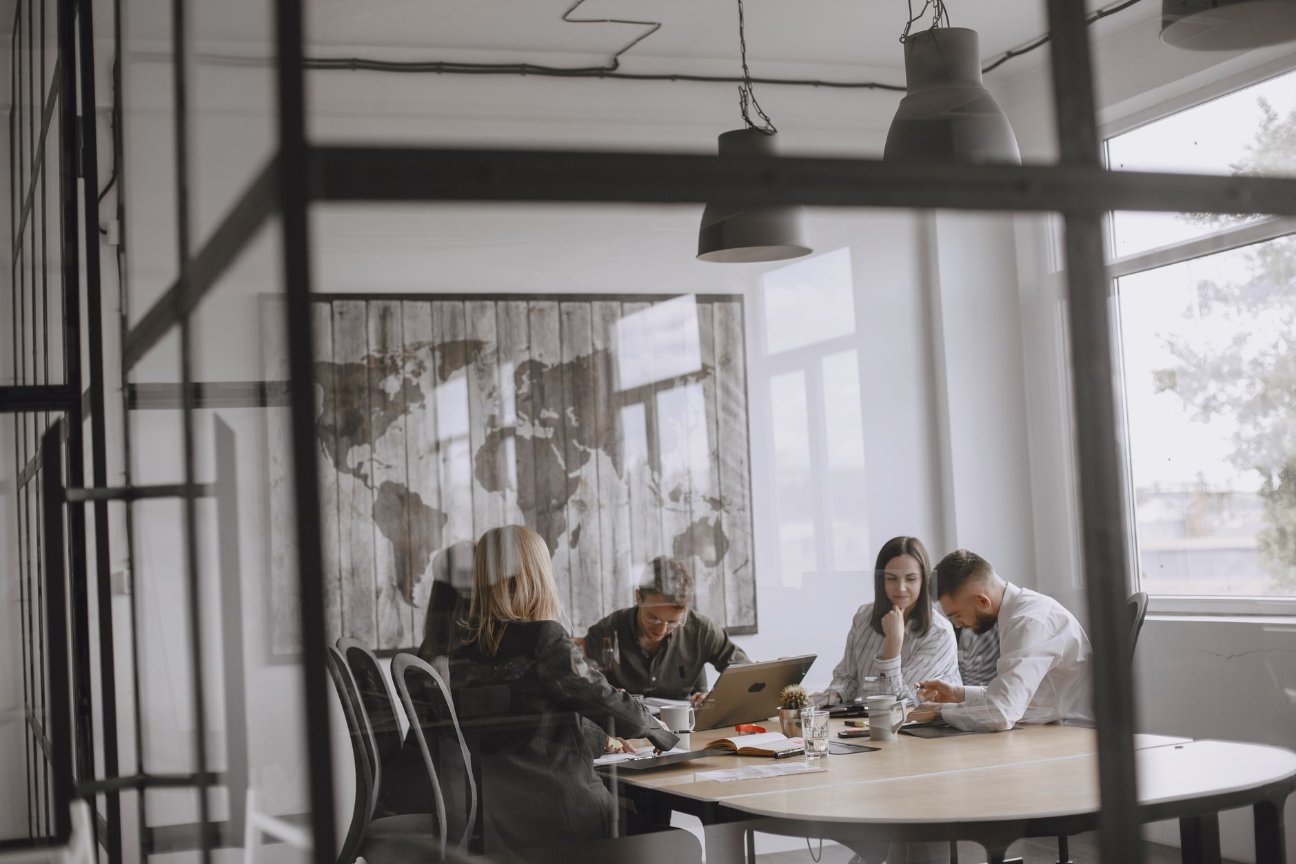 A group of professionals collaborate in a modern office with