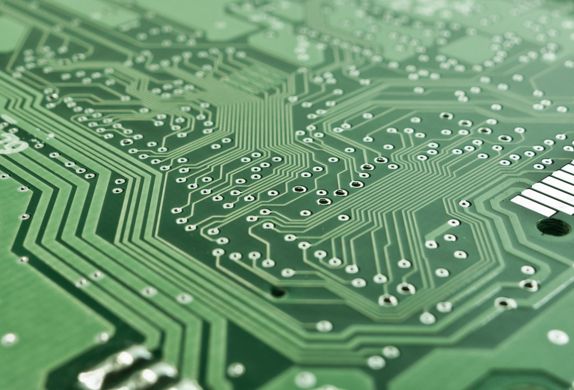 Detailed view of a green circuit board with complex patterns