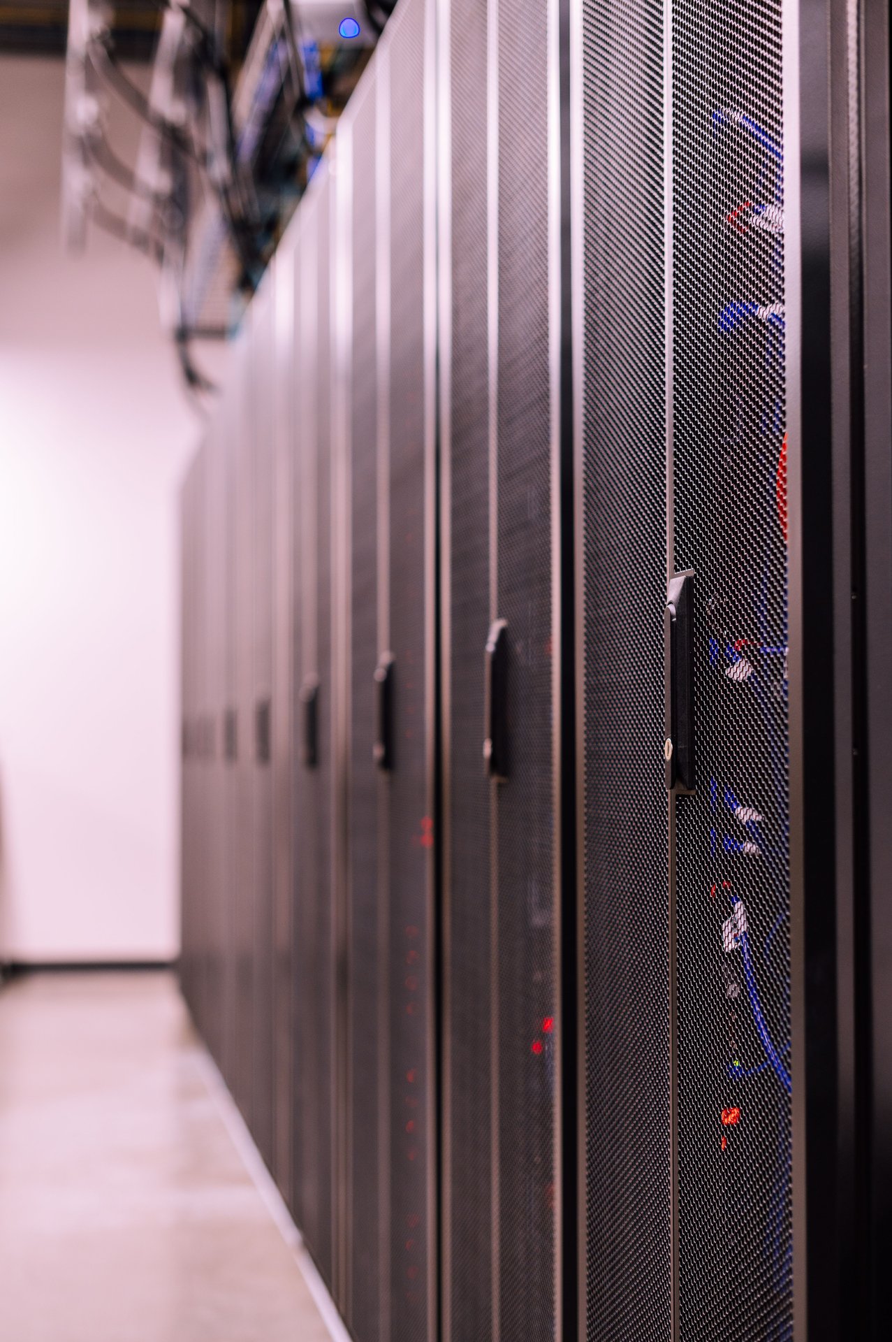 Row of similar lockers with various optic fiber cables in mo