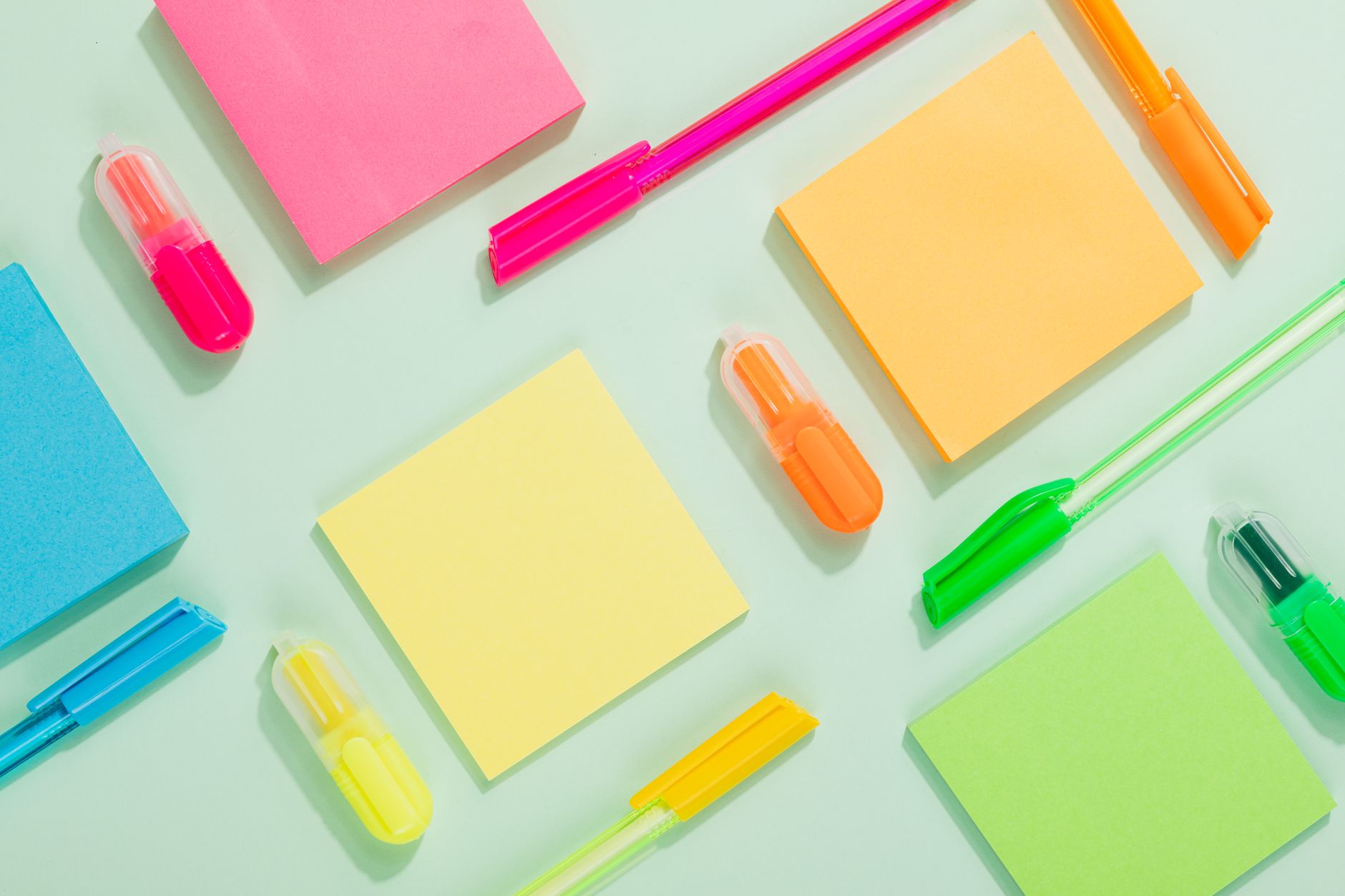 A vibrant selection of sticky notes and pens arranged in a f