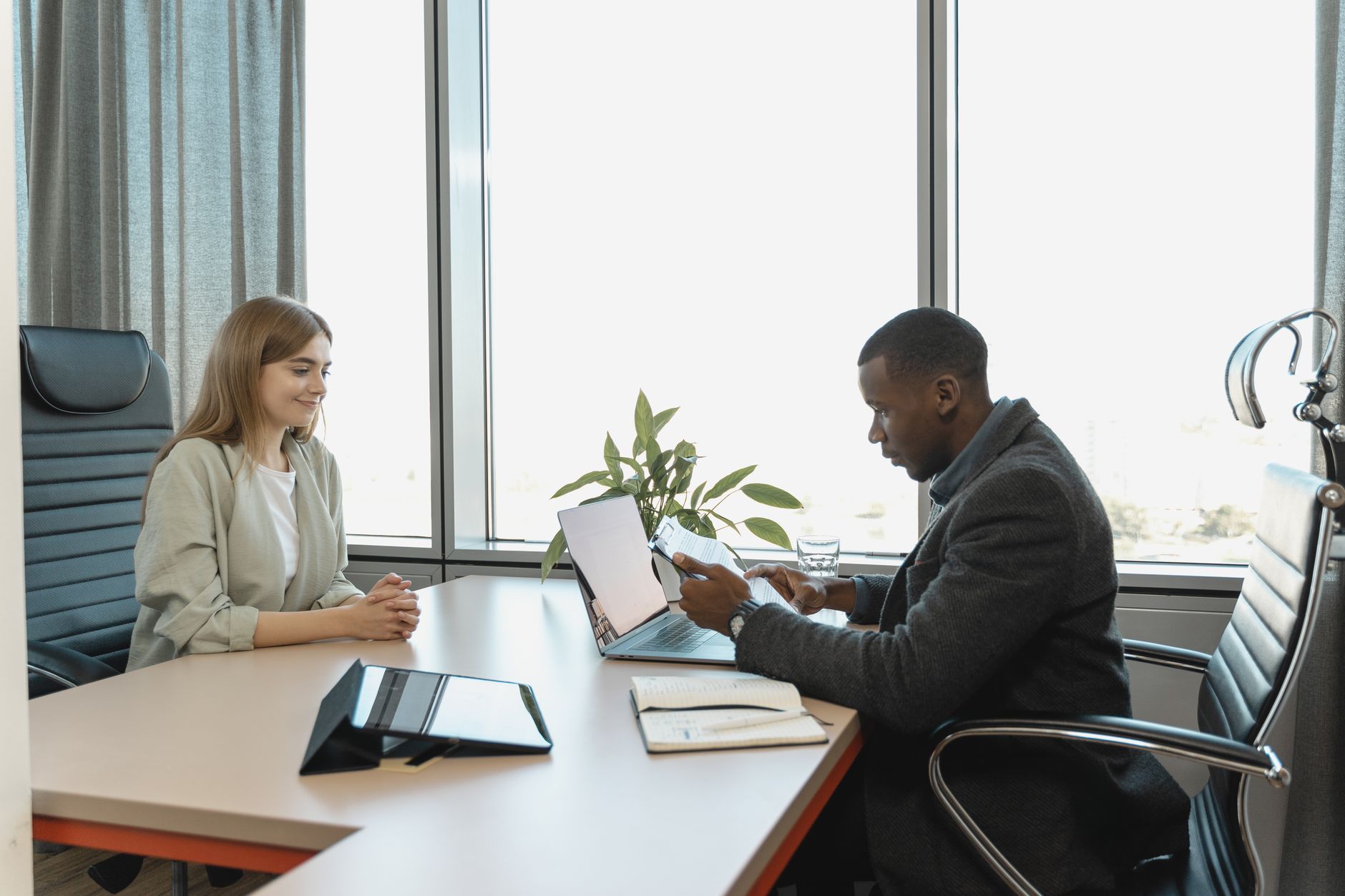 Business meeting with diverse professionals discussing a job