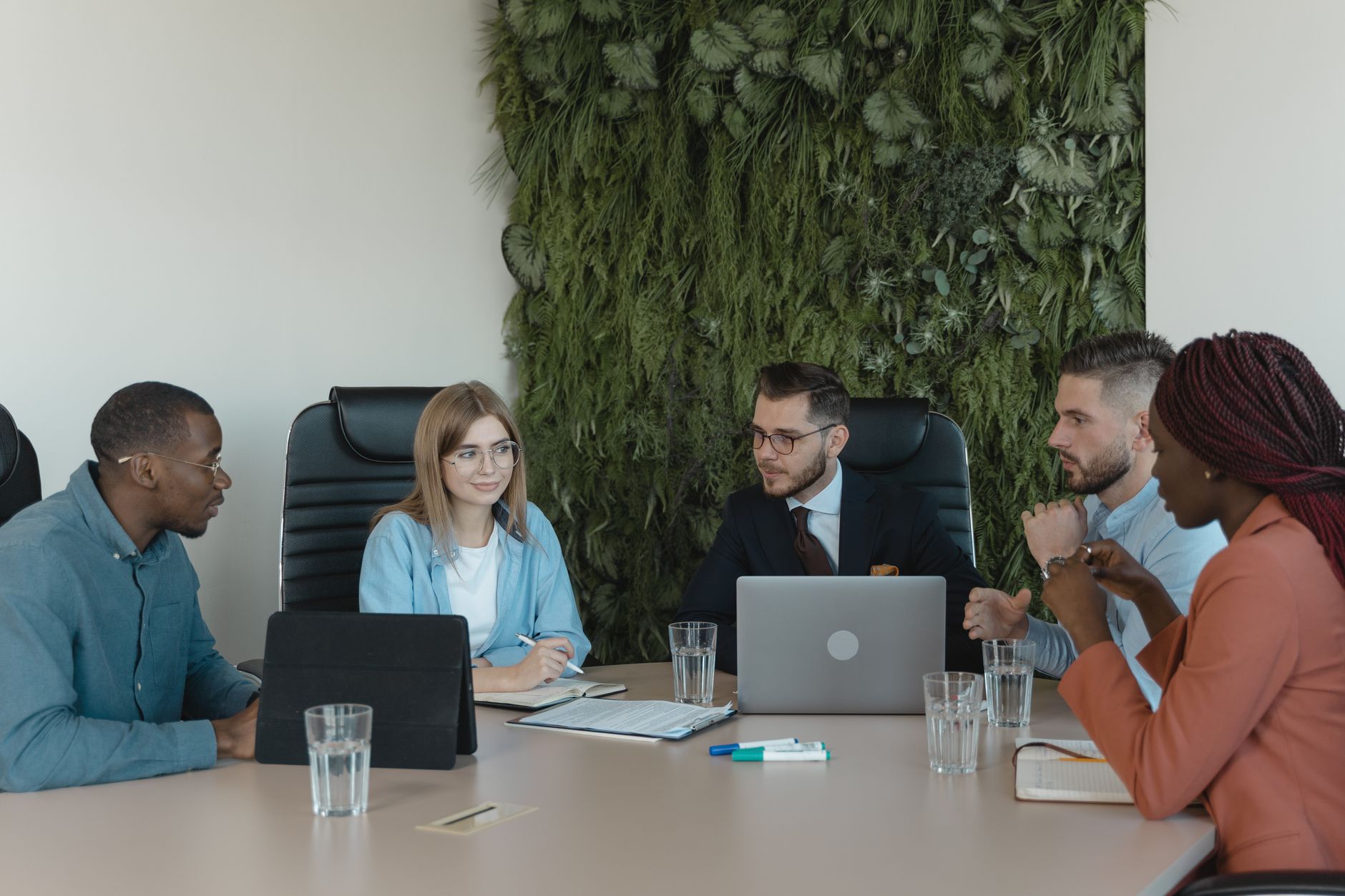 A group of diverse professionals discussing a project in a m