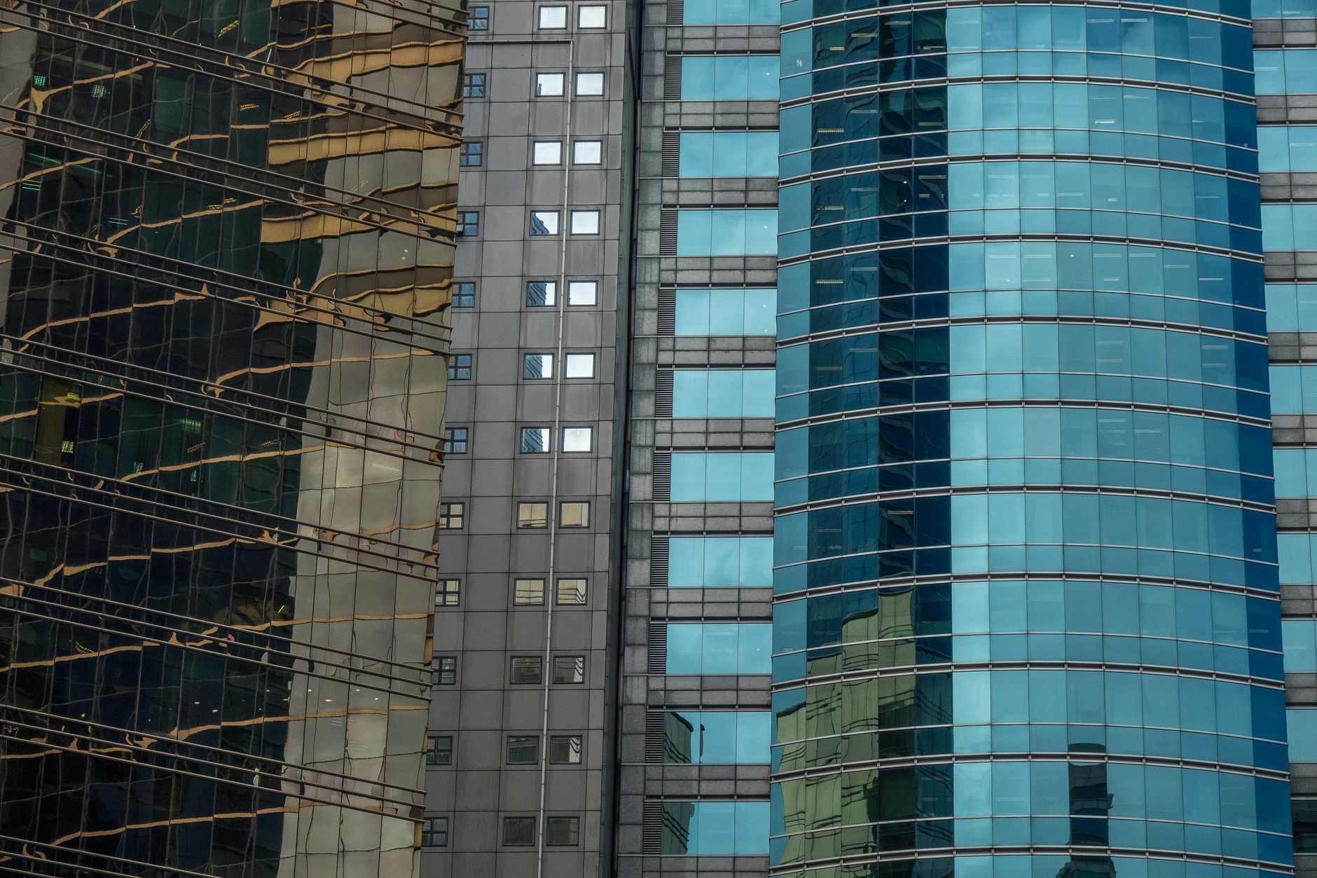 An urban cityscape of skyscraper facades with glass reflecti