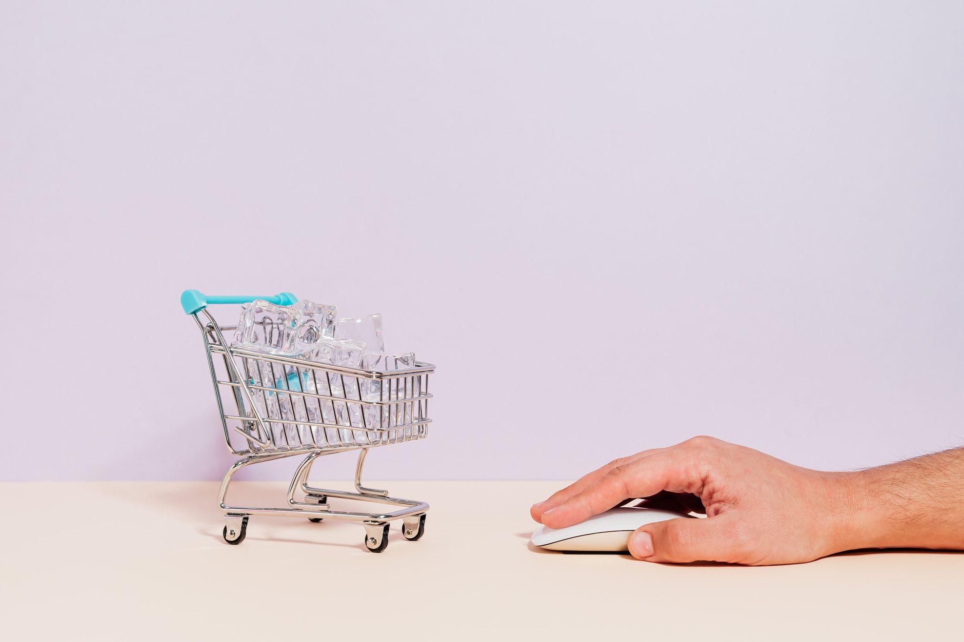 Conceptual image of a hand on a mouse next to a miniature sh