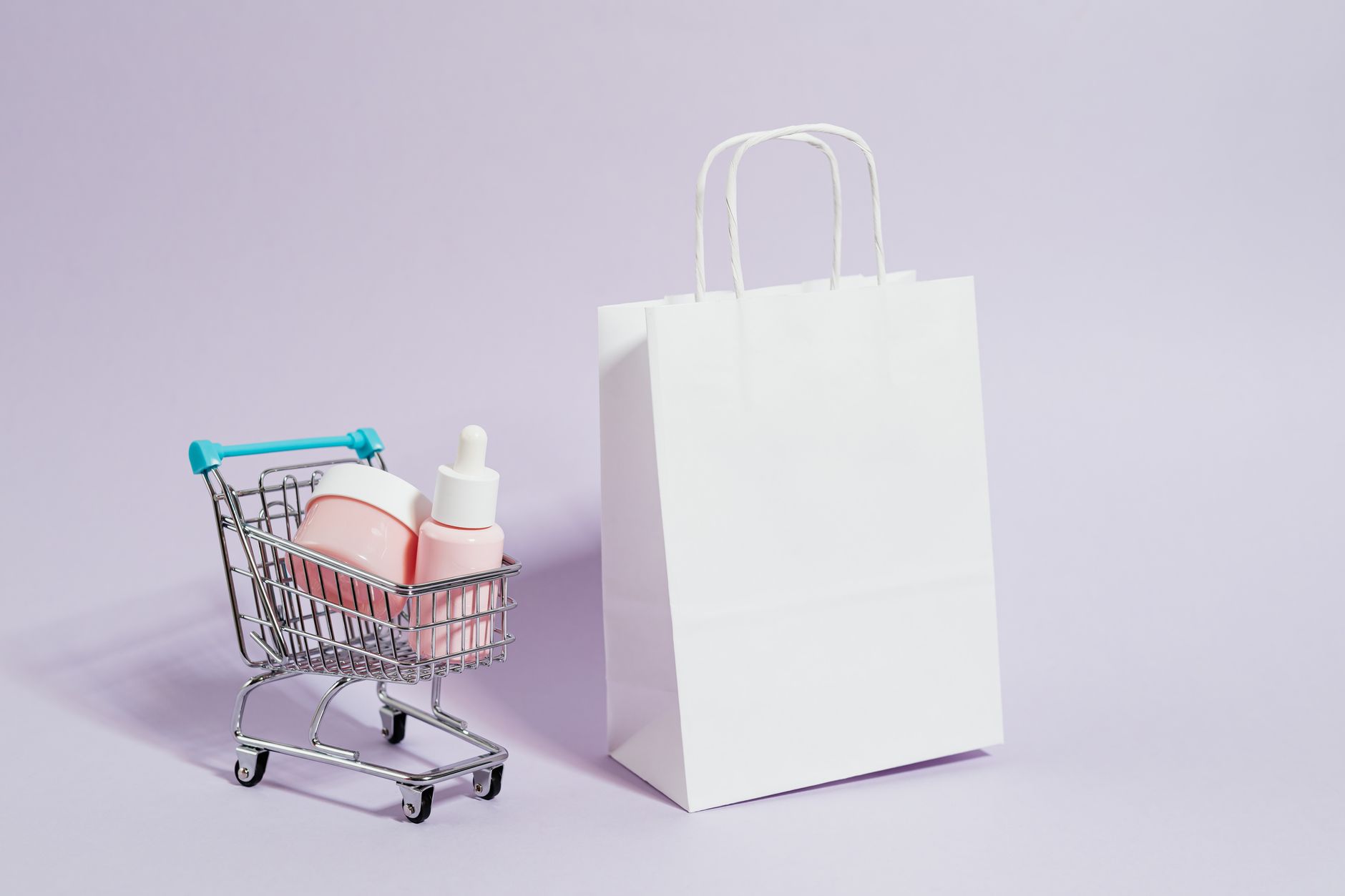A minimalist image featuring a shopping cart with cosmetics