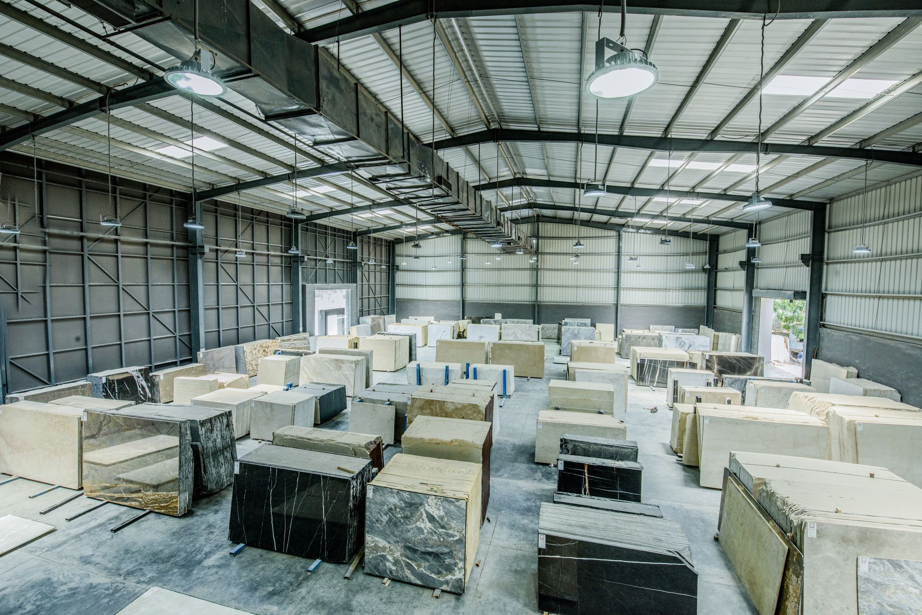 Expansive warehouse filled with large stone slabs for indust