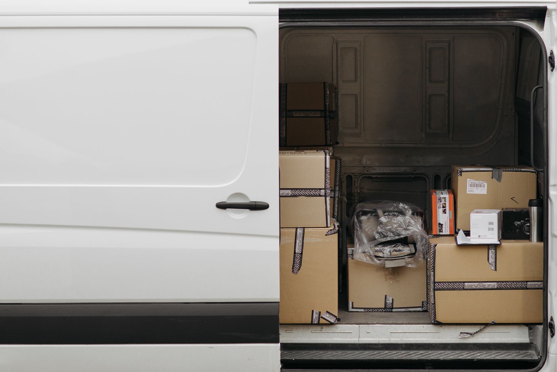 Open delivery van filled with boxes, ready for logistics and