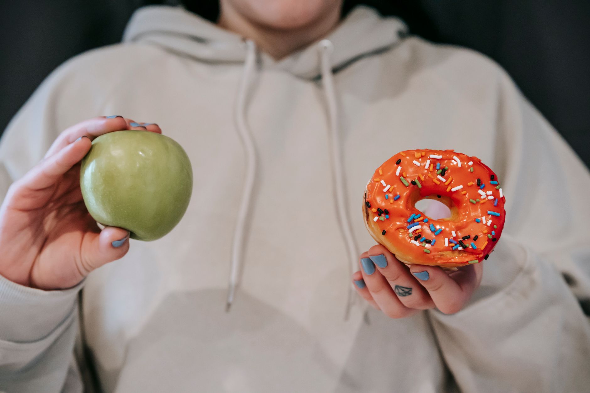 Crop unrecognizable female in loose hoodie showing healthy g