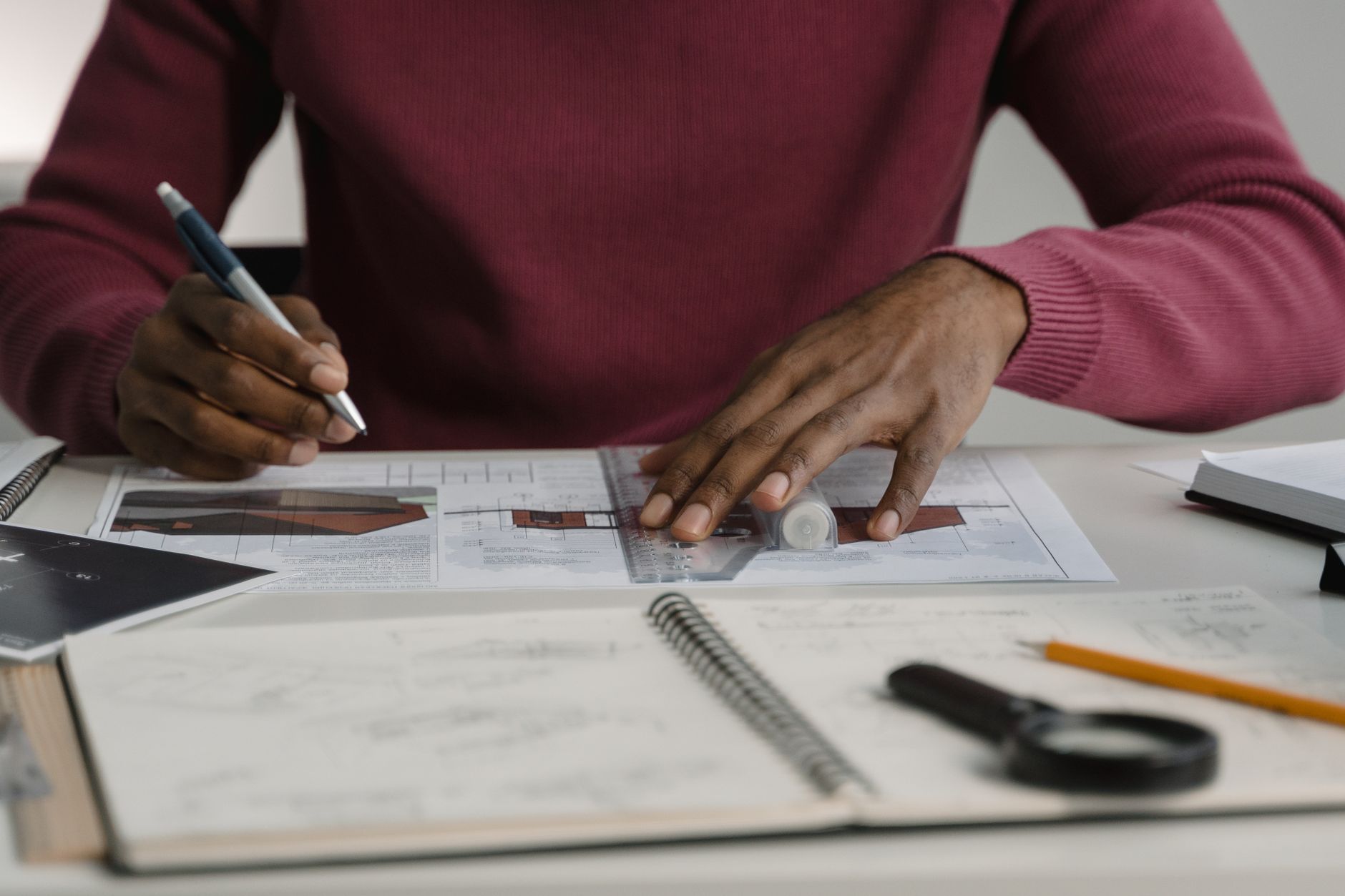 Professional architect working with blueprints and tools at