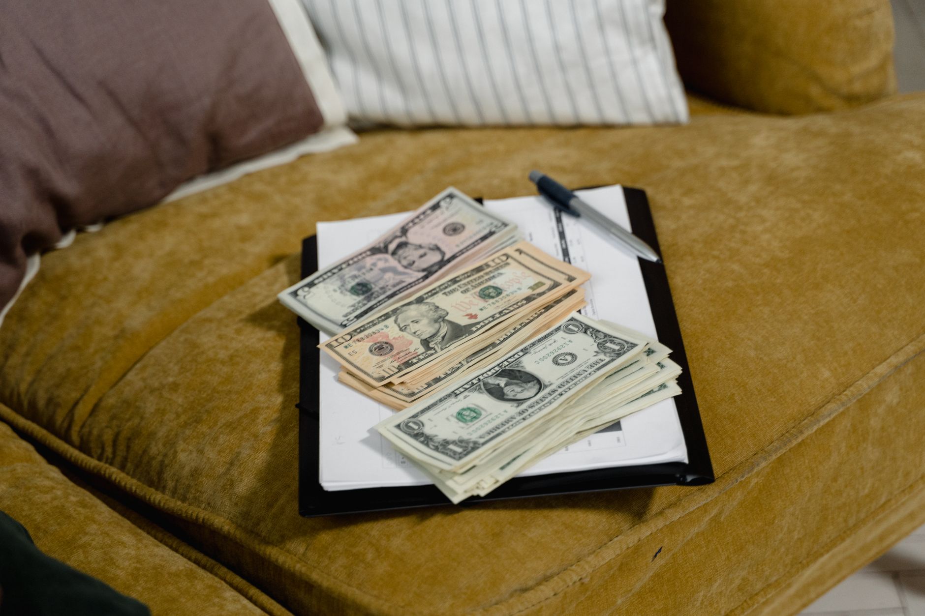Close-up of US dollar banknotes on a sofa, symbolizing finan
