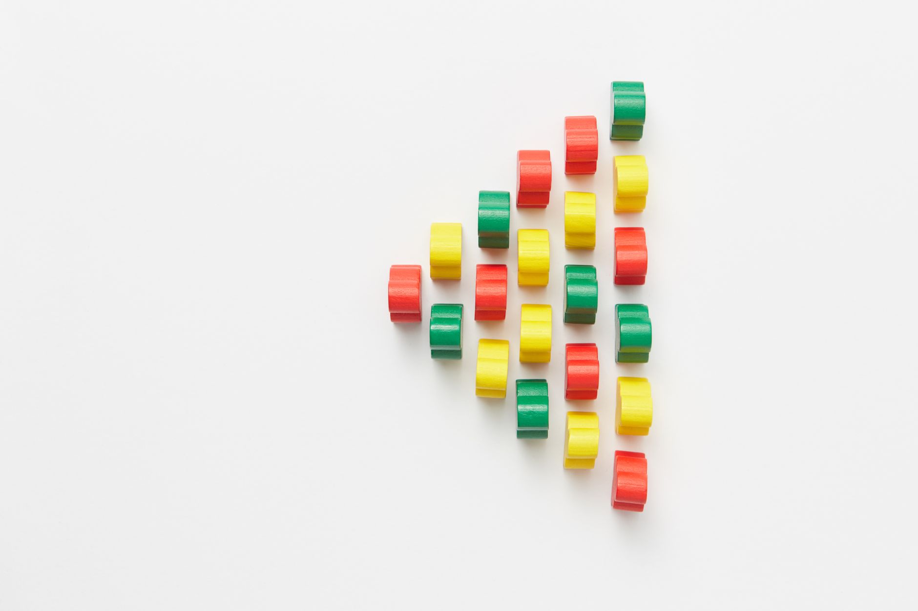 Vibrant arrangement of colorful plastic pieces on a white ba