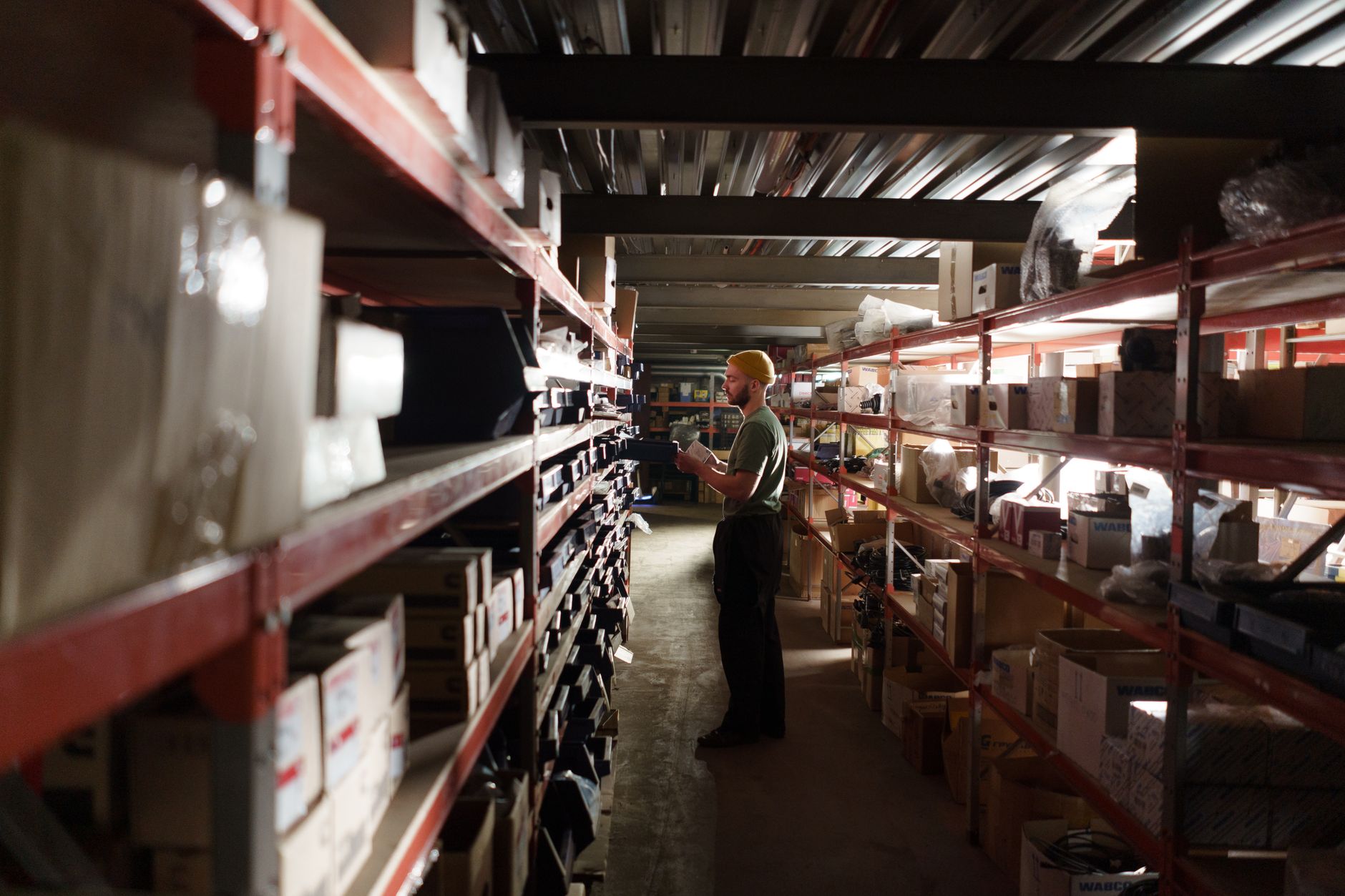 A warehouse worker sorting items on shelves in an organized