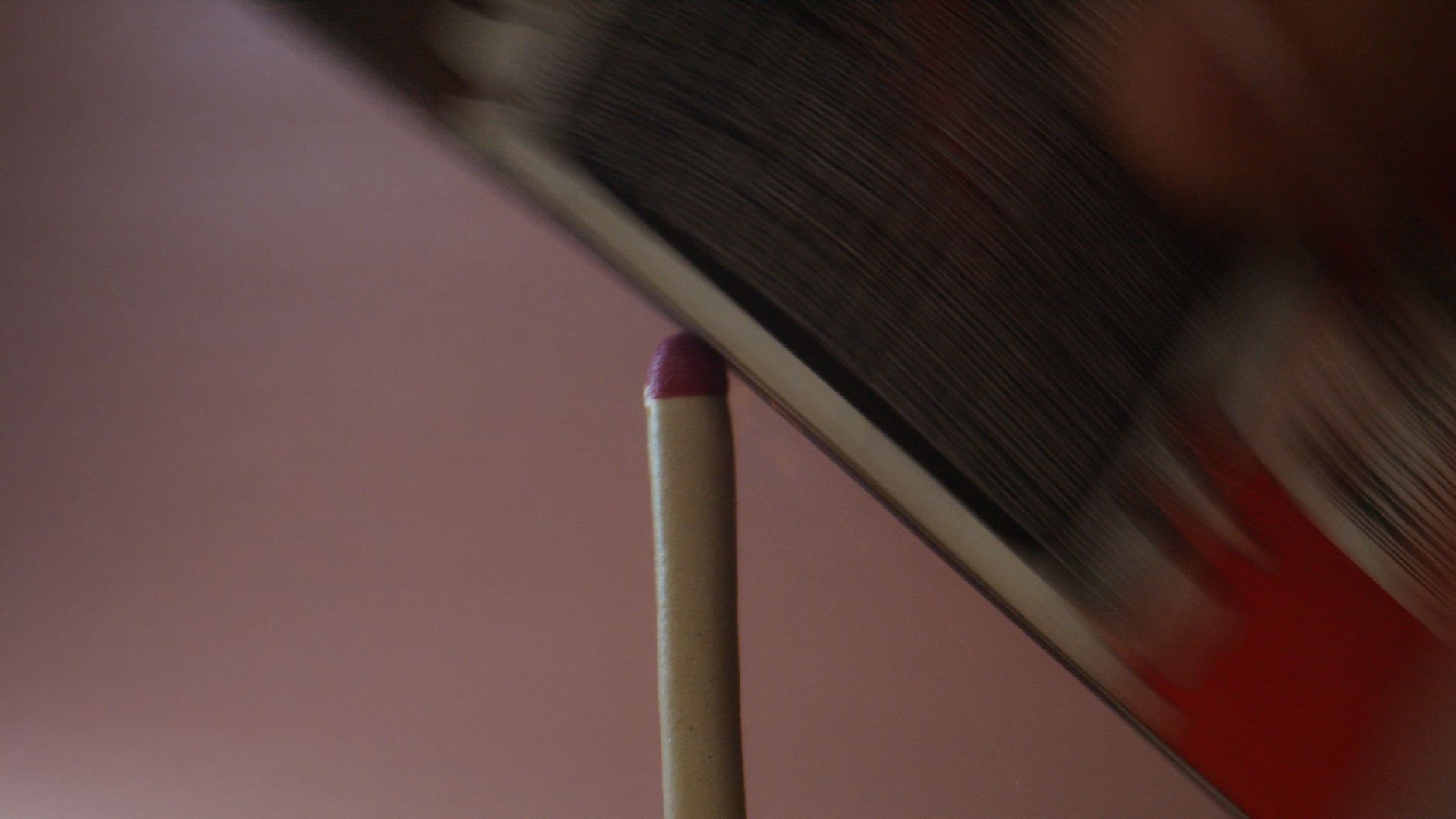 Close-up of a matchstick being struck, showcasing friction i
