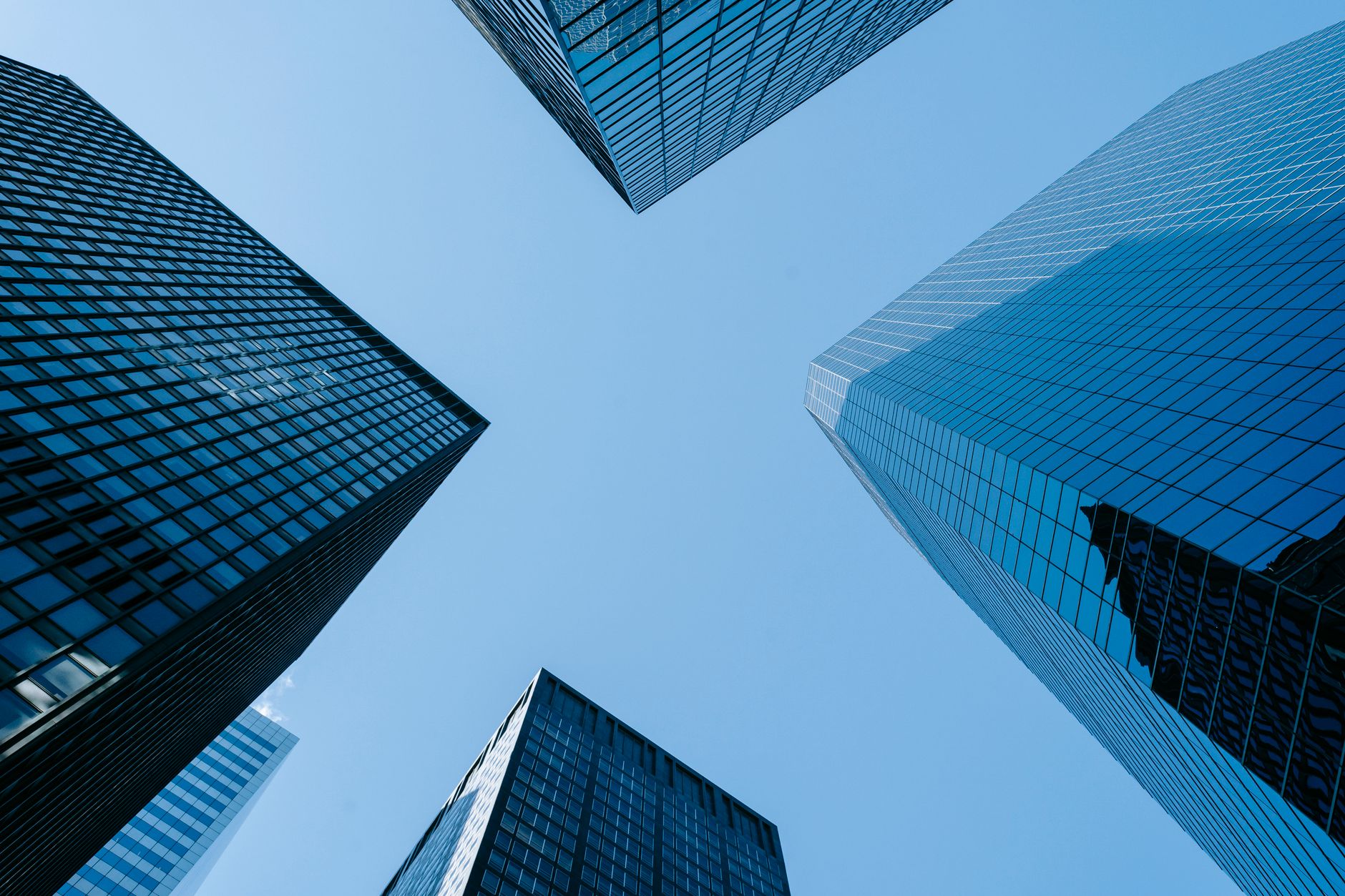 Low angle of high business towers with glass mirrored window