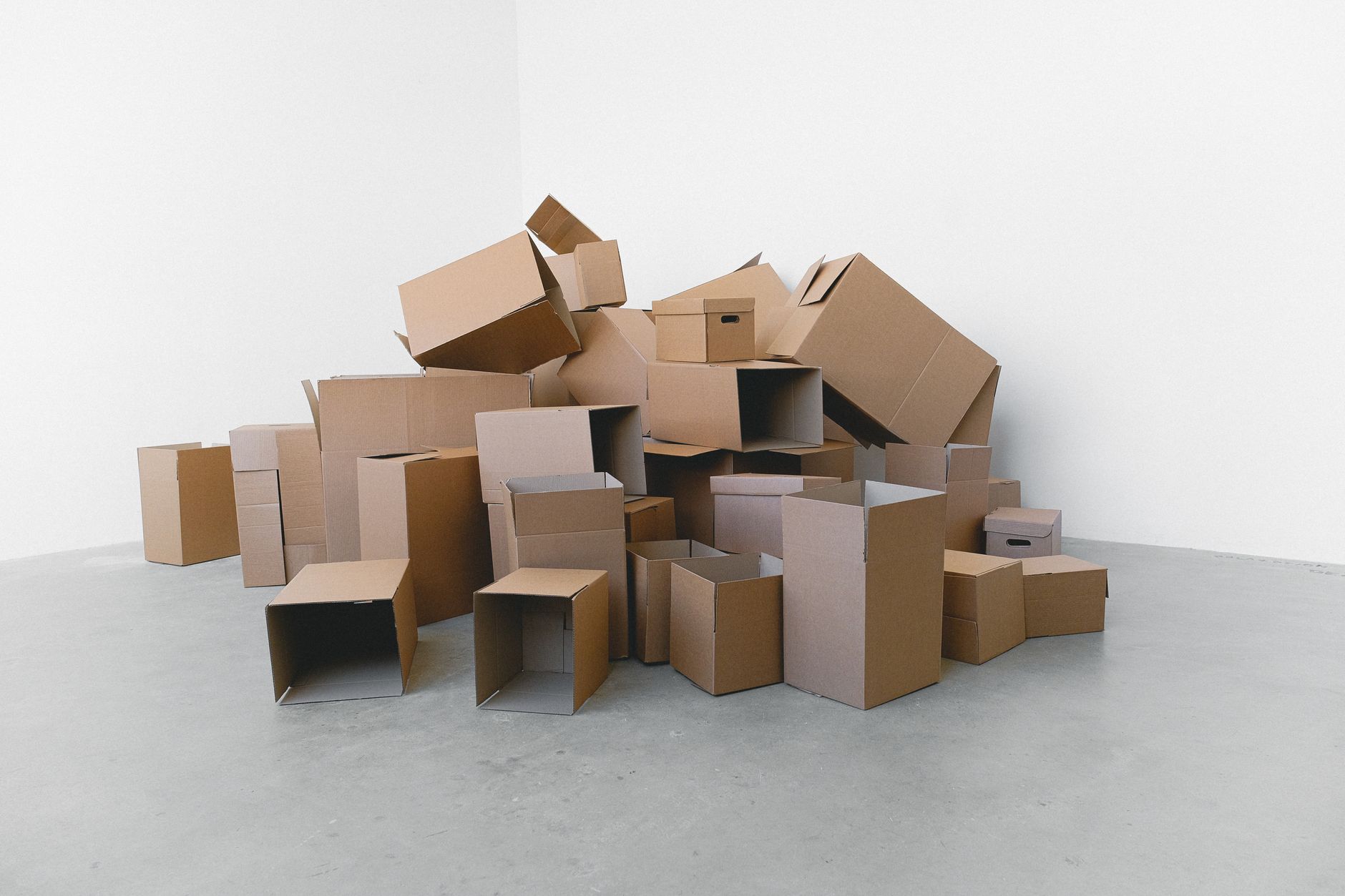 Pile of cardboard containers prepared for relocation on floo