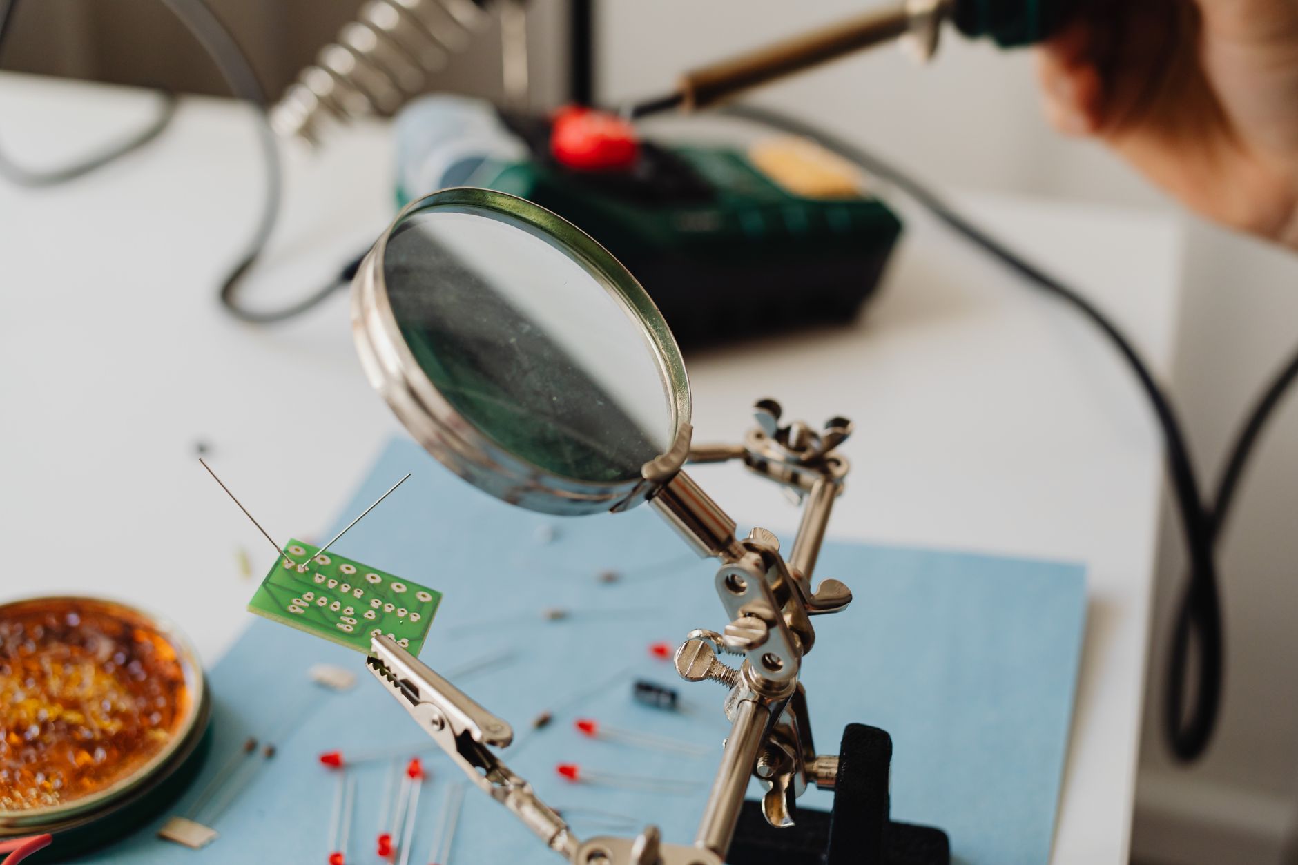 Detailed view of a magnifying glass examining a small circui