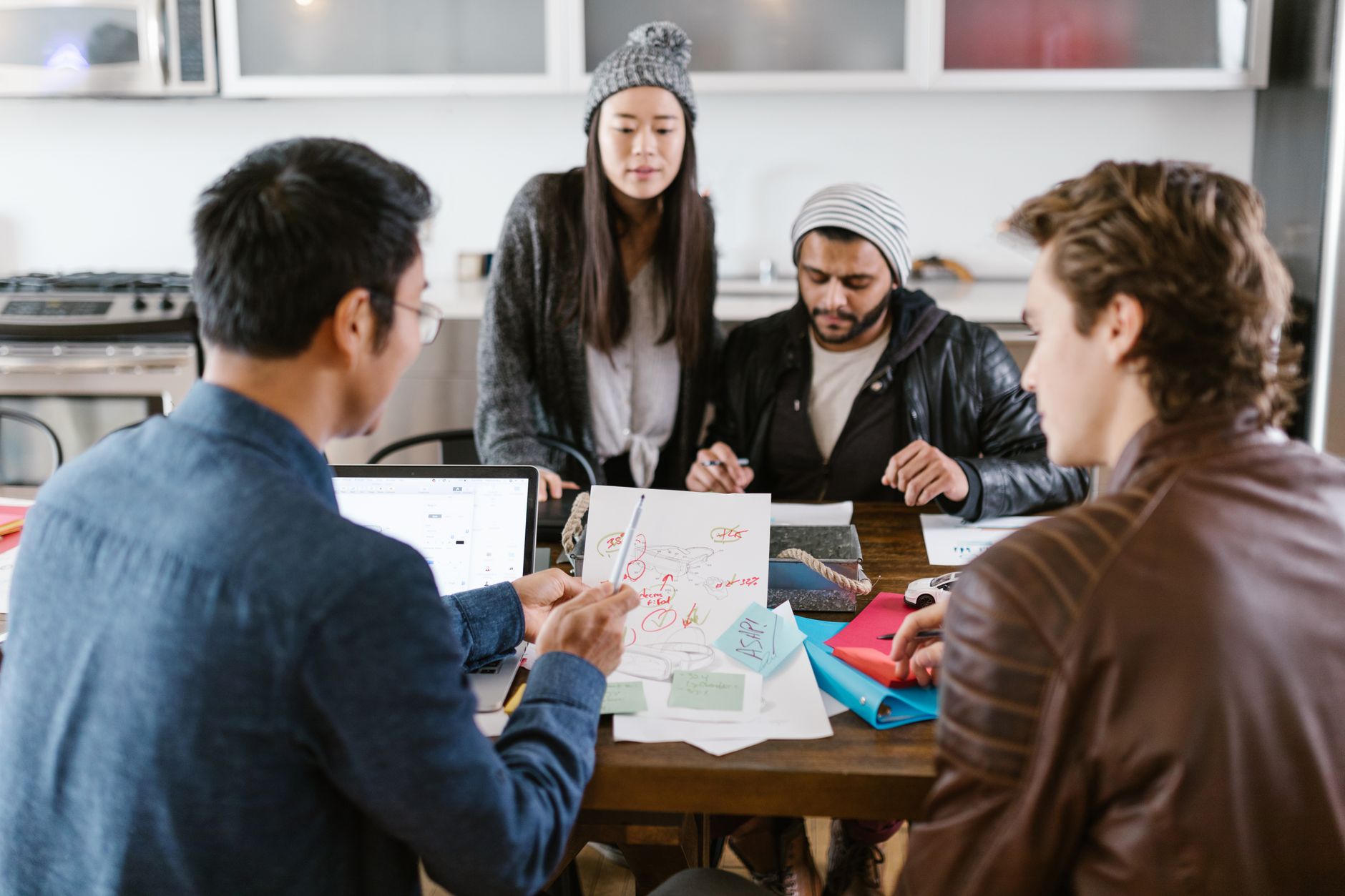 Group of diverse adults brainstorming ideas during a meeting