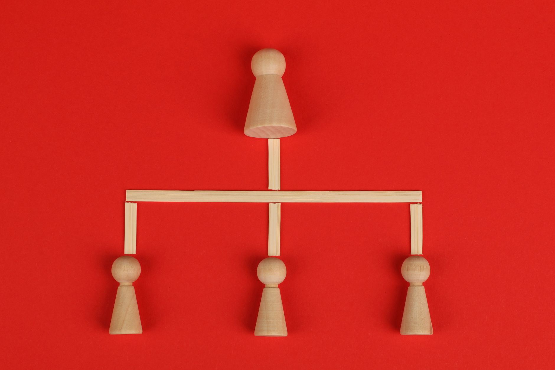 Conceptual depiction of hierarchy using wooden pieces on a v