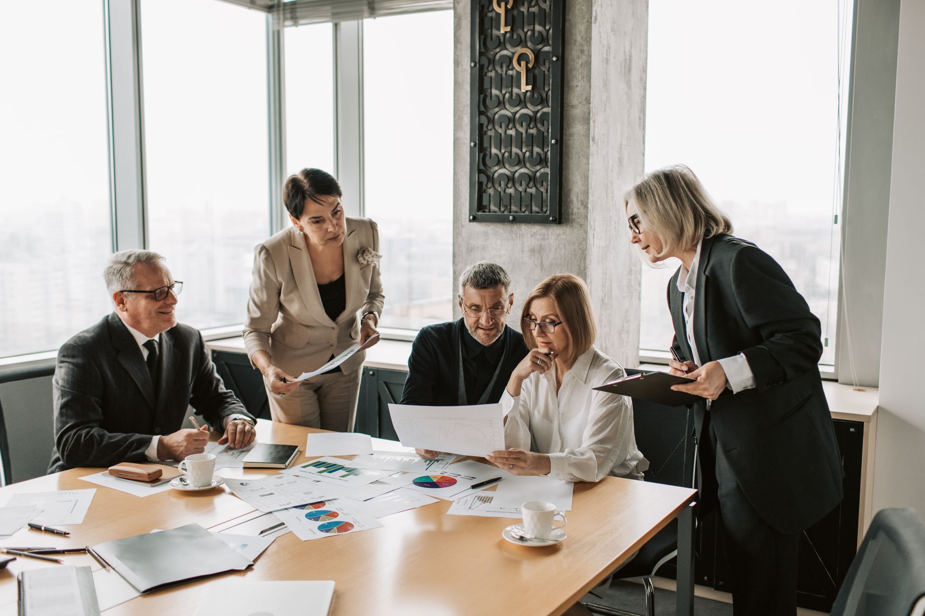 Business professionals engage in an office meeting to analyz