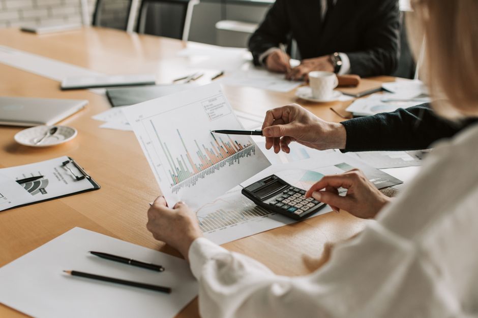 Professionals reviewing financial graphs and charts during a