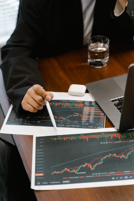 Close-up of a business analyst reviewing printed financial g