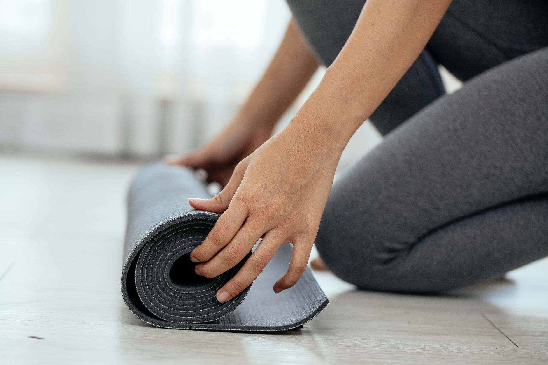 Side view of crop unrecognizable female sitting on floor and