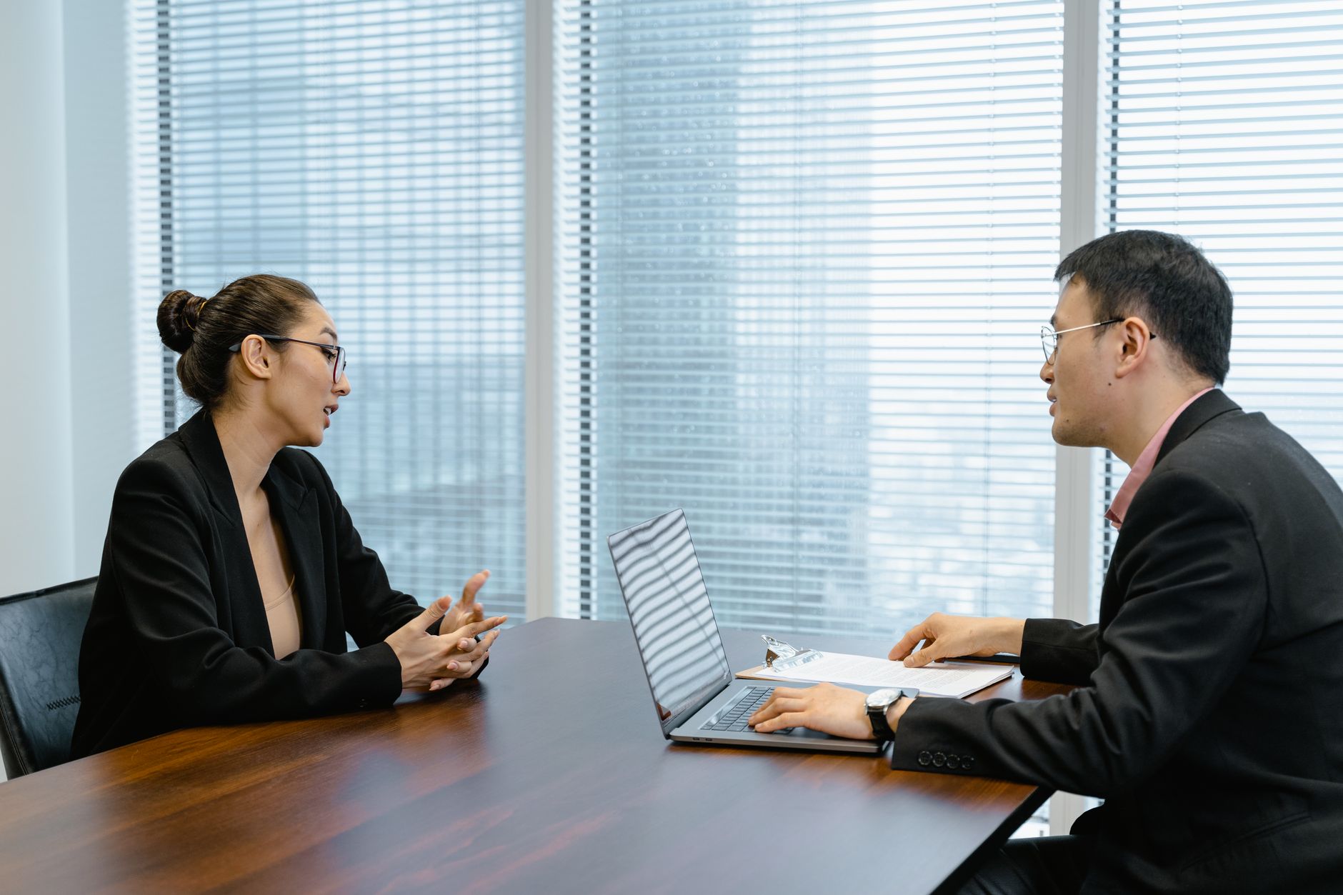 Two colleagues in a professional meeting discussing business