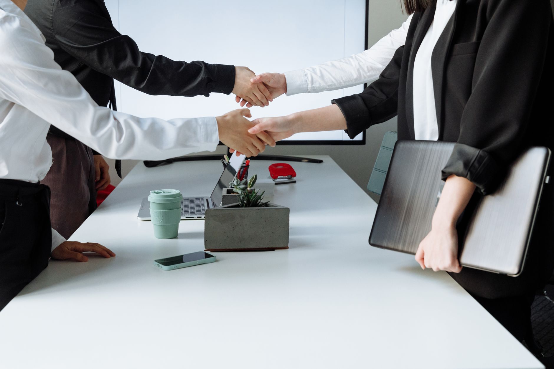Professionals sealing a deal with a handshake across a confe