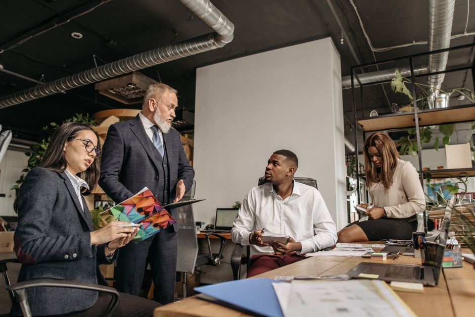 Diverse colleagues engaged in a business meeting in a contem