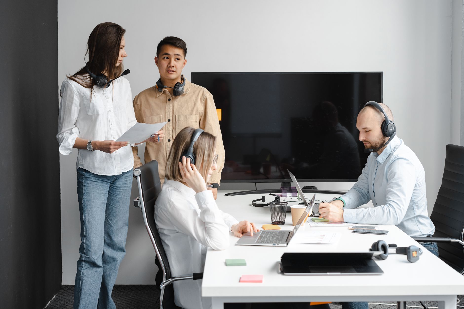 Group of call center agents working together in a modern off