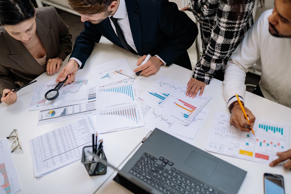A group of professionals reviewing financial charts in an of