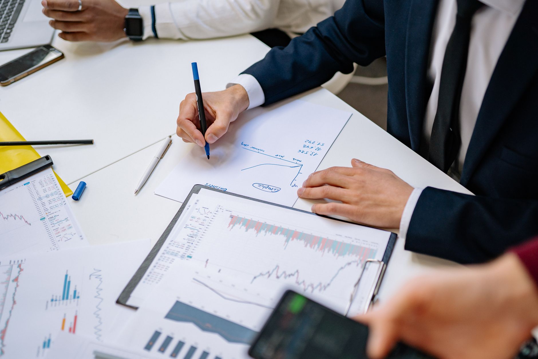 Professionals analyzing financial charts in a corporate sett