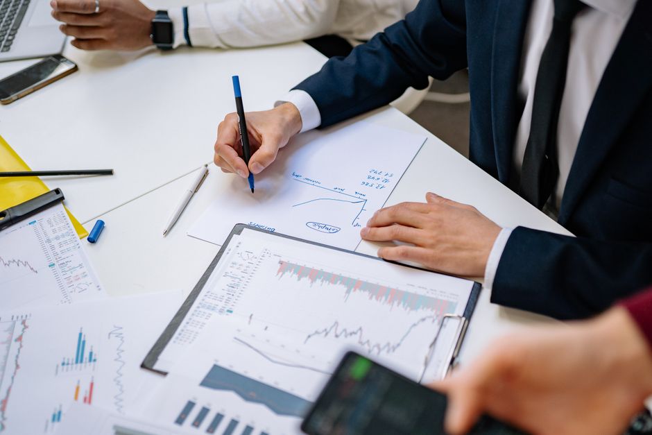 Professionals analyzing financial charts in a corporate sett