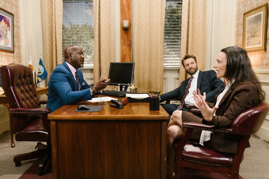 Three attorneys in a legal discussion at a well-appointed la