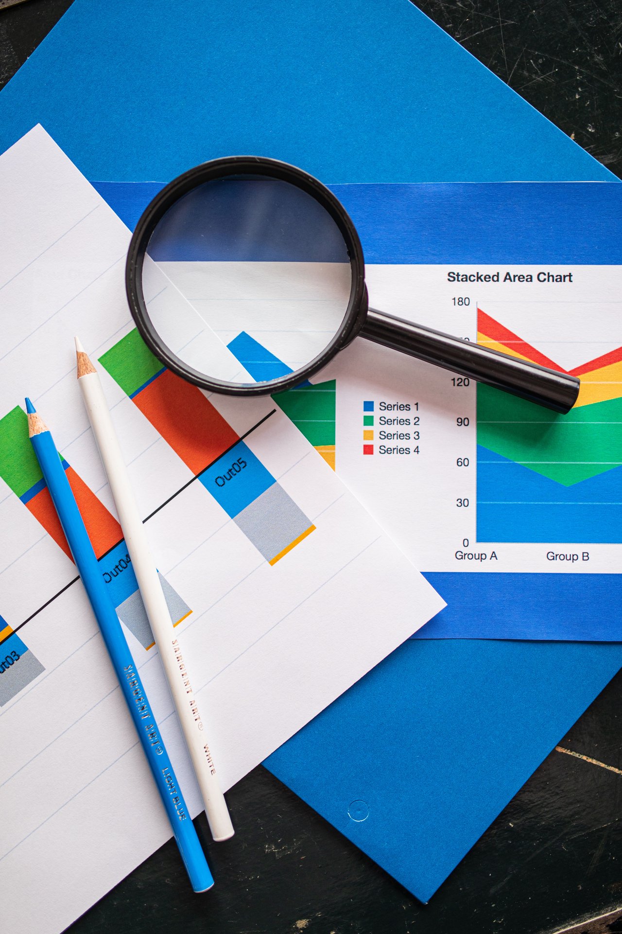 Image of financial charts and magnifying glass, ideal for bu