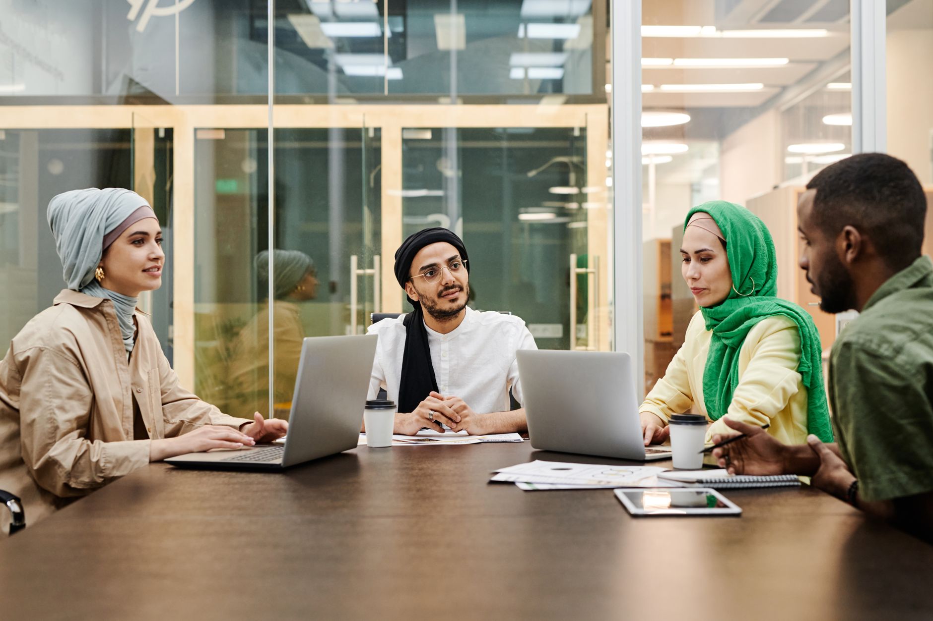 A diverse group discussing ideas in a modern office setting,
