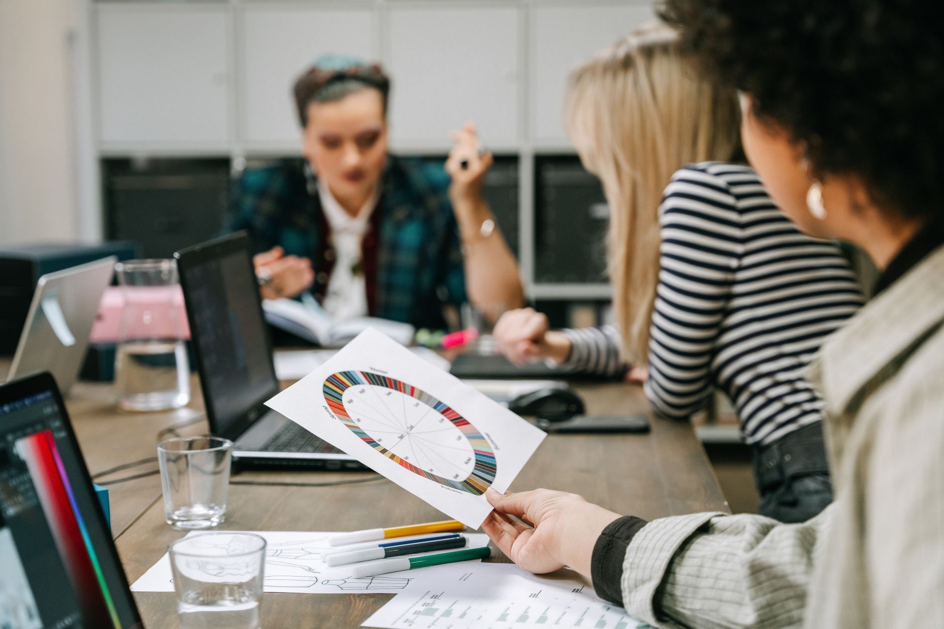 Group of colleagues discussing color wheel and planning in a