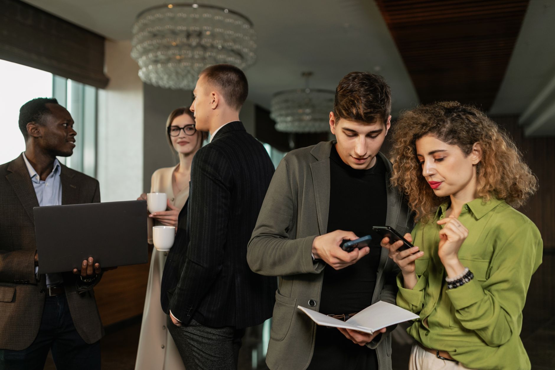 Group of diverse business professionals networking indoors w