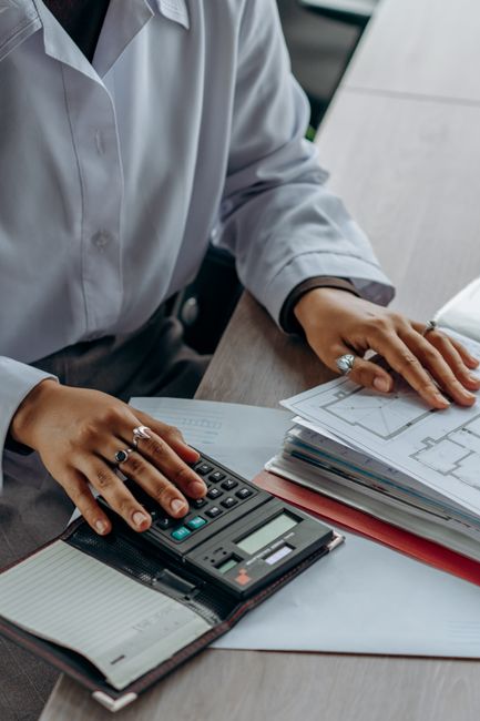 Accountant calculates finances with a calculator and documen