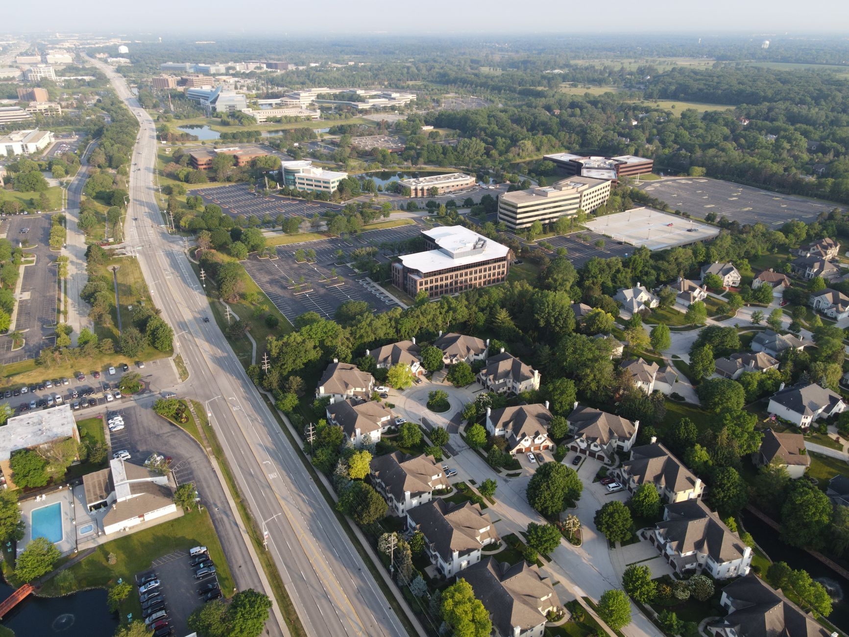 Aerial photo showcasing suburban Lisle, IL with roads, trees