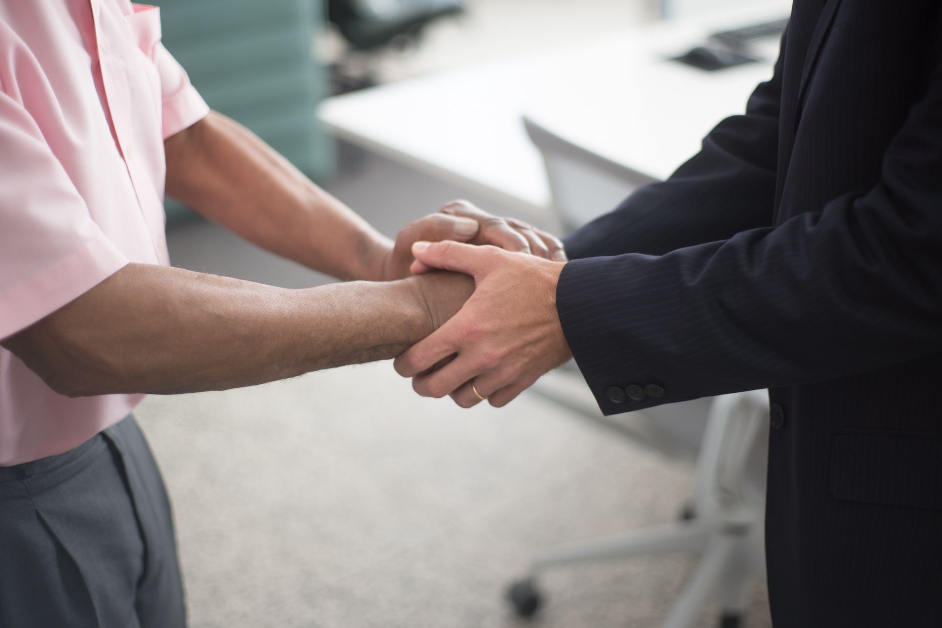 Close-up of a formal handshake between two businessmen in an