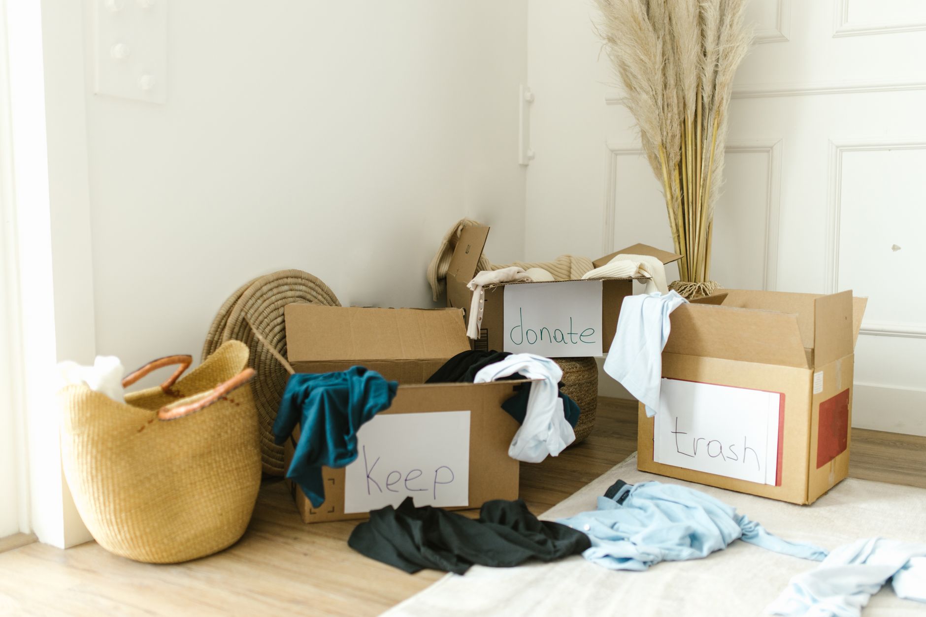 Cardboard boxes labeled 'Keep', 'Donate', and 'Trash' for ho