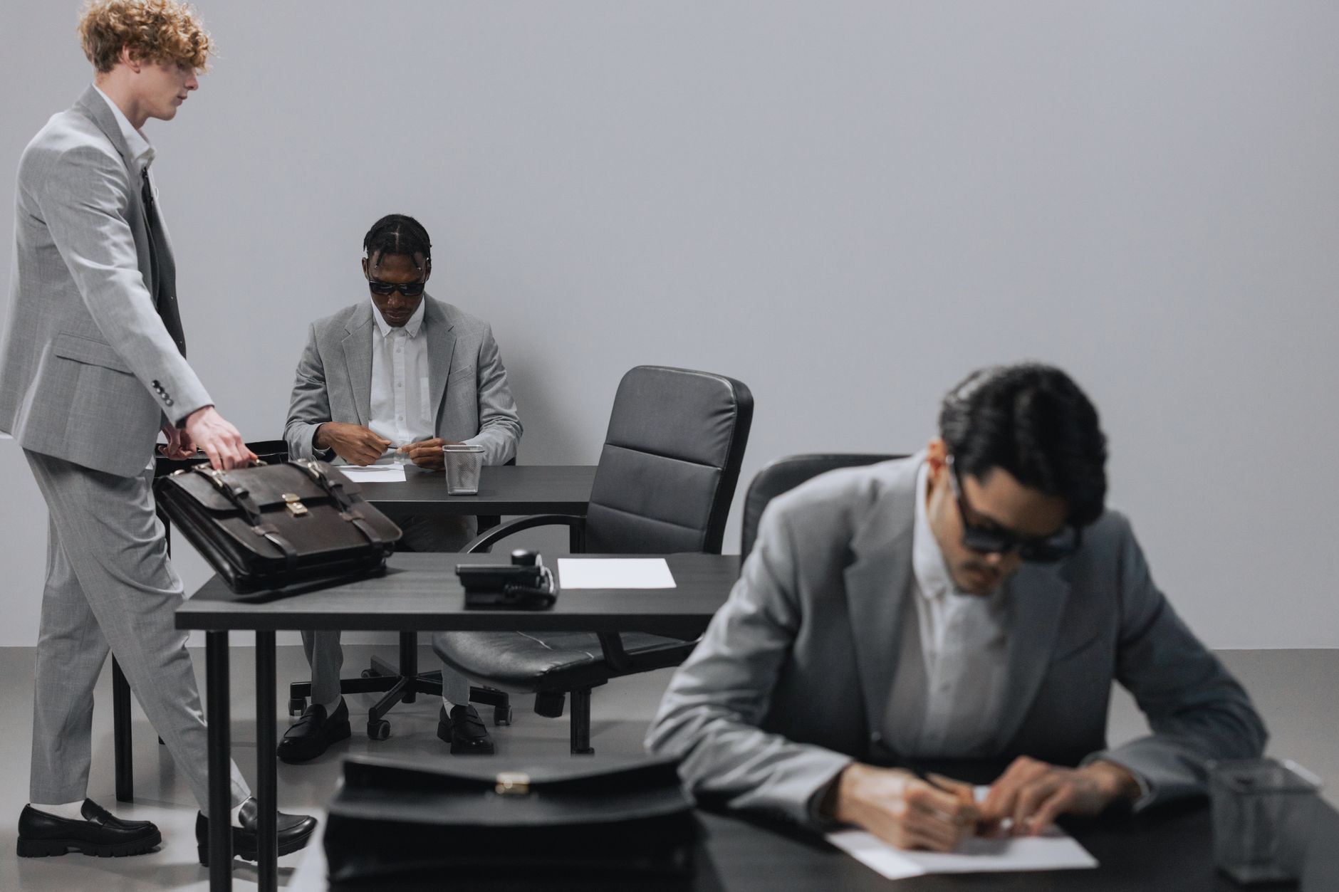 Business office with diverse employees in gray suits working