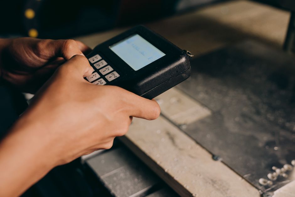 A detailed close-up of hands operating an electronic control