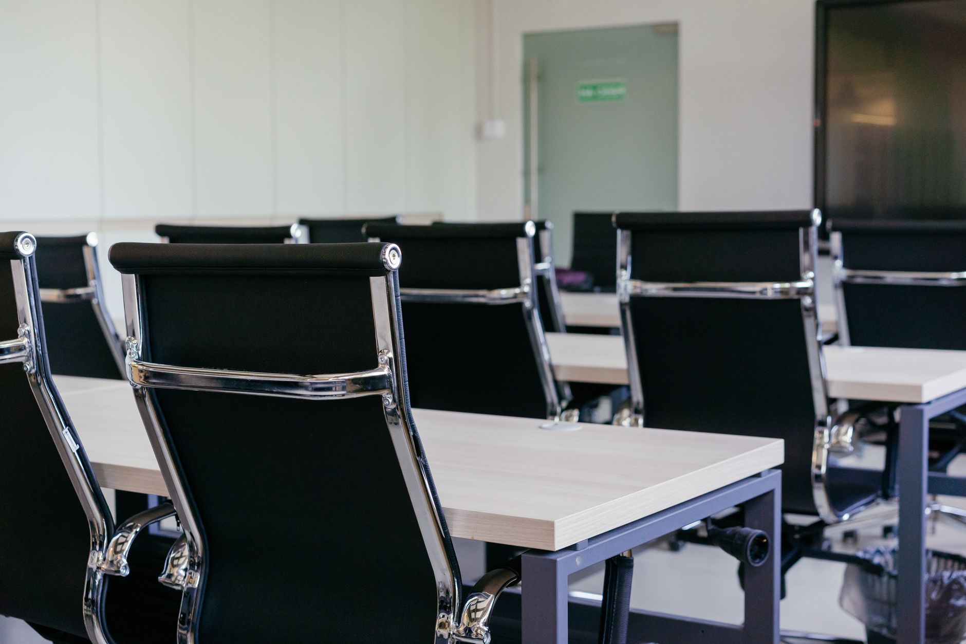 Sleek modern conference room with black chairs and white des