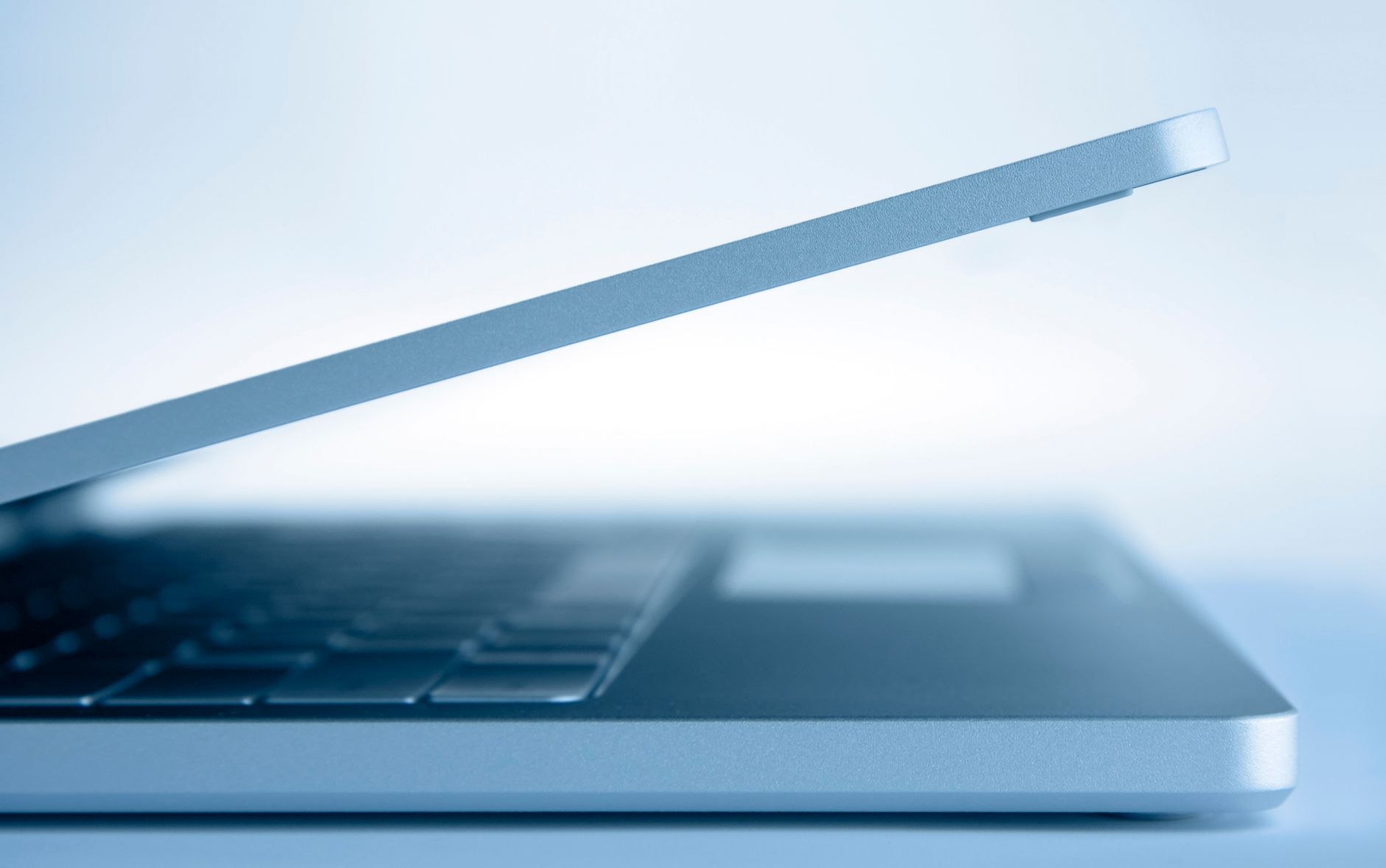 Profile view of a sleek modern laptop in a minimalist style,