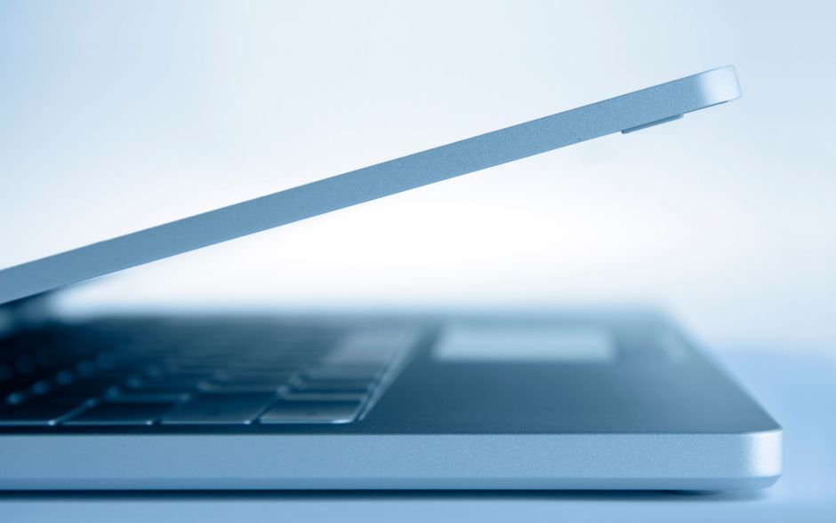 Profile view of a sleek modern laptop in a minimalist style,