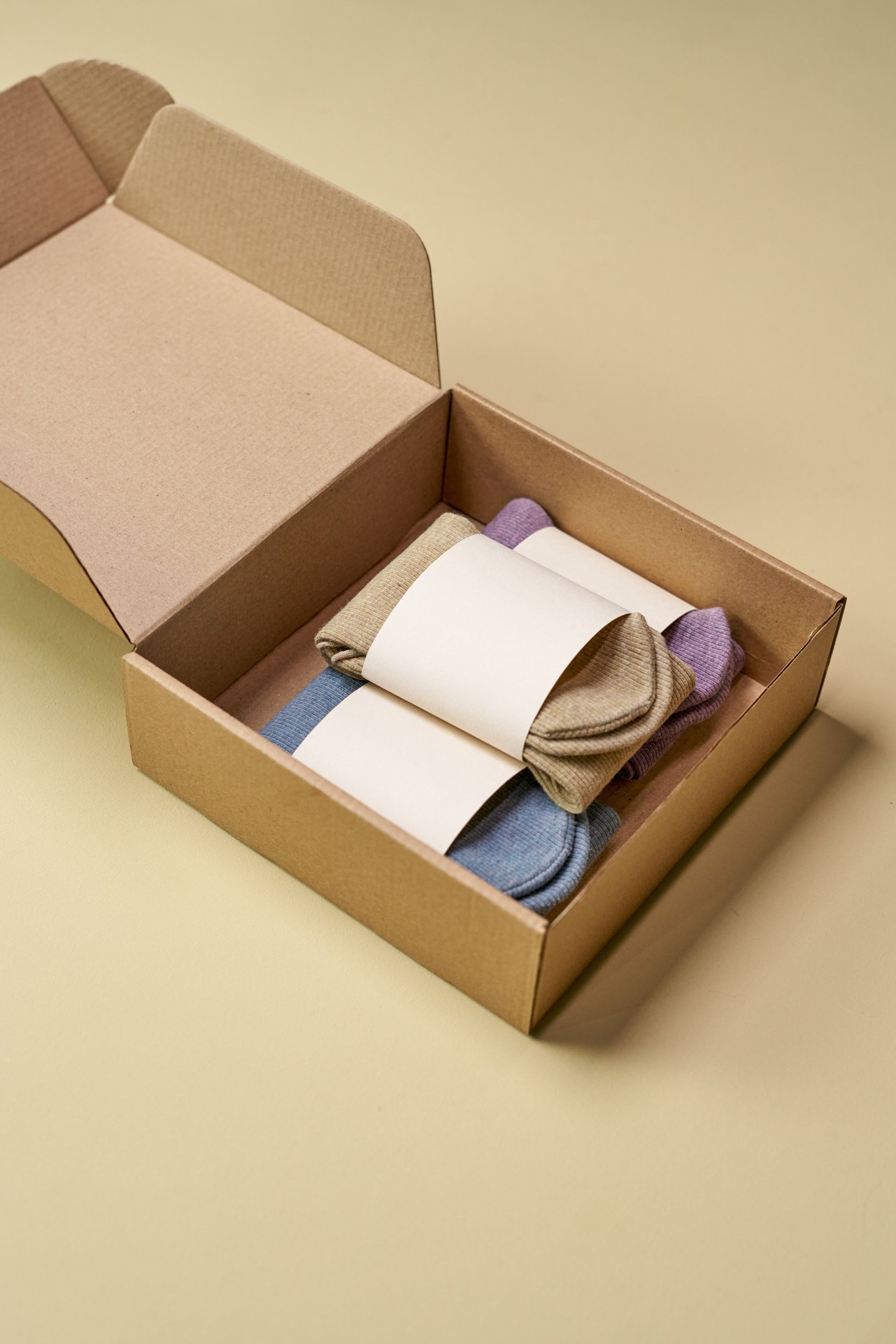 Minimalist cardboard box with colorful eco-friendly socks on